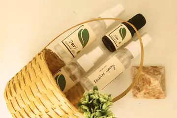 savi essential oils and sprays placed gently beside a basket on the floor.