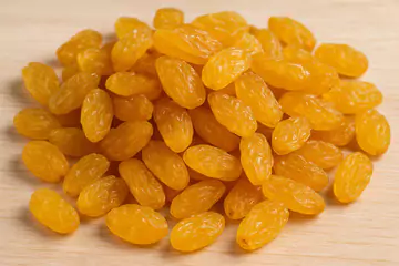 thompson seedless raisins on a wooden table.