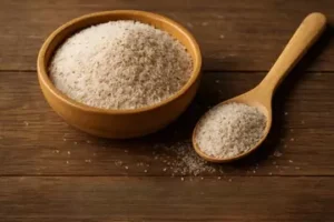Psyllium Husk bowl filled with psyllium husk and a wooden spoon placed beside it.