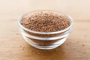 Psyllium Husk psyllium husk seads in a glass bowl on a wooden table.
